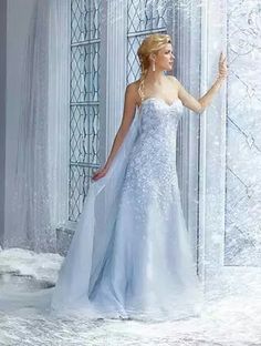 a woman in a wedding dress standing next to a window with snow falling on it