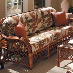 a living room filled with furniture next to a large window and a table in front of it