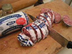 sliced up meat sitting on top of a cutting board