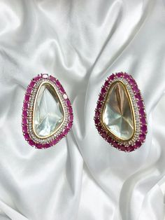 Beautiful vintage uncut polki stud earrings with silver diamond work and a modern luxurious look for any jewelry lover! The Pink stones are a beautiful pop of color with the bold diamond in the middle and these are the perfect statement earrings beautifully handmade for all occasions! These lightweight and elegant stud earrings is perfect for any bridesmaid, bride, sangeet or any occasion or event as a gift for any occasion as any one who loves jewelry will love this statement piece. It has beautiful colors that really make the set a statement piece. Product Details: * Earrings  Ready to Ship and available immediately if you place an order today! Fast Shipping US Customers receive your order within 5-7 business days. This is the actual product picture so no surprises (please note colors ma Bollywood Style Diamond Earrings For Gift, Polki Studs, Ruby Earring, Pink Stud Earrings, Polki Earrings, Pink Stones, Pink Studs, Bridal Dress Fashion, Earrings Indian