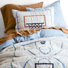 the comforter is made up with basketballs and hoop on it's side