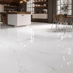 a kitchen with white marble floors and cabinets