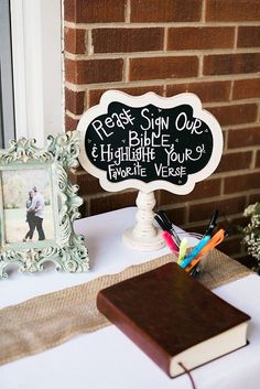 there is a sign on the table that says please sign one and highlight your favorite verse