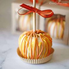 an orange and white striped cake pops on a table