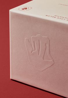 a pink box with an image of a hand on it