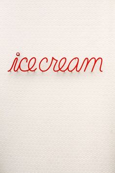 the word ice cream written in red on a white background