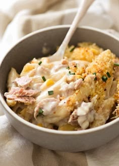 a close up of a bowl of food on a cloth with a spoon in it