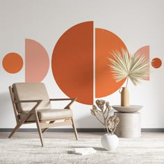 two chairs and a vase in front of a wall with an orange circle on it