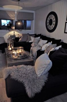 a living room filled with lots of black and white furniture