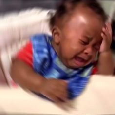 a baby crying while laying in a crib