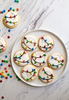 cookies decorated with icing and colored sprinkles on a plate