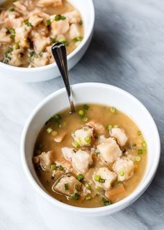 two bowls filled with soup on top of a table