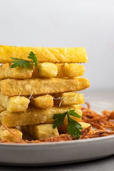 a stack of fried food sitting on top of a white plate