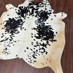 a cowhide rug with black and white spots