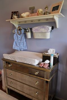 a baby's crib in the corner of a room next to a dresser