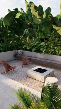 an outdoor living area with lots of plants and furniture on the ground, including two lounge chairs