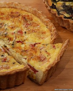 a quiche is cut into pieces on a wooden table