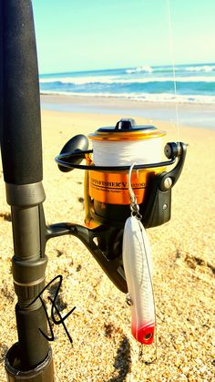 a fishing rod and reel on the beach