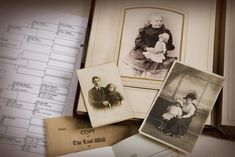 old family photos are displayed on top of an open binder with papers and other items