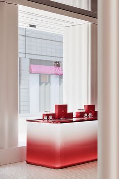 a red and white counter sitting in front of a window