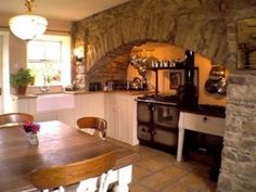 the kitchen is clean and ready to be used for cooking or dining, with an oven in the corner