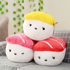 three stuffed toys are stacked on top of each other in the shape of sushi