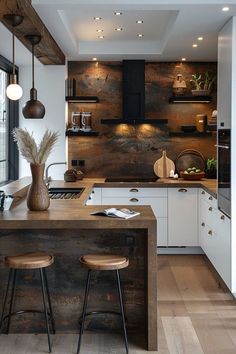 a kitchen with two stools next to an island in the middle of the room