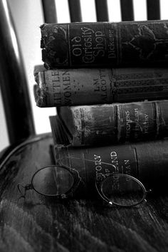 a stack of books sitting on top of a wooden table