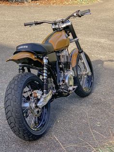 a brown motorcycle parked on the side of a road