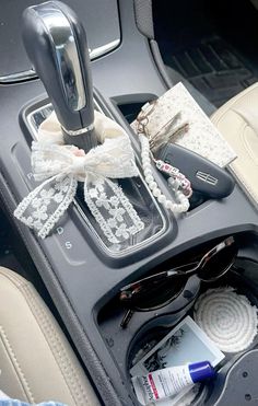 the inside of a car with sunglasses and other items sitting on the floor next to it