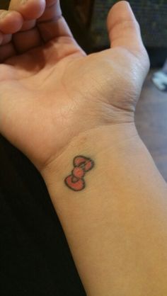 a person's arm with a small tattoo on the wrist and number 3 tattooed on it