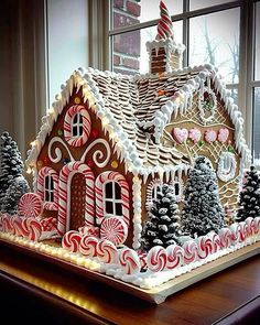 an elaborate gingerbread house with candy canes on the roof