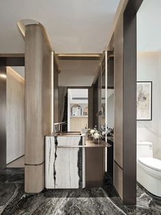 a bathroom with marble flooring and walls