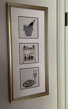 two framed pictures hang on the wall next to a wine glass and bottle rack with bottles in it