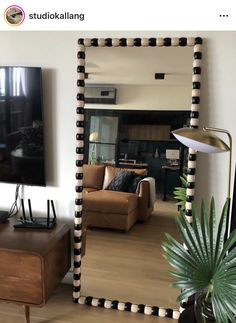 a living room with a large mirror on the wall