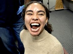 a woman with her mouth open and teeth wide open