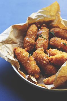 a bowl filled with fried food on top of a table