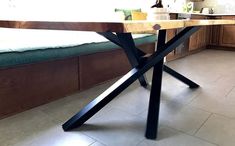 a kitchen with a table that has been made out of wood and black metal legs