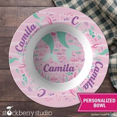 personalized pink and green plate with mermaids on it, sitting next to a plaid napkin