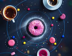 a doughnut with pink icing and sprinkles sits on a plate next to two cups of coffee