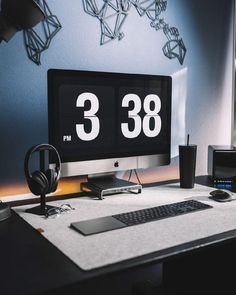 a desktop computer sitting on top of a desk next to a mouse and headphones