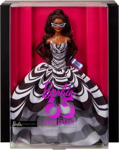 a barbie doll in a black and white dress with purple lettering on the chest,