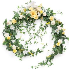 an arrangement of yellow and white flowers arranged in a circle on top of each other