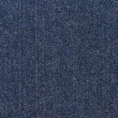 an up close shot of blue denim fabric textured with coarsed flecks