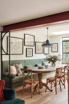 a living room filled with furniture next to a dining table and chairs in front of a window