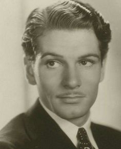 an old black and white photo of a man wearing a suit