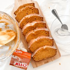 sliced loaf of orange cake next to bowl of yogurt