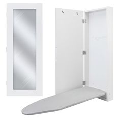 an ironing board is next to a white wall mounted cabinet with a mirror on it