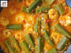 a pot filled with vegetables and shrimp on top of a stove