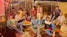 a group of young men sitting on top of a wooden floor next to each other